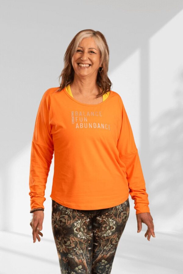 Creating | Orange long sleeve activewear top for women